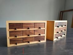 two wooden drawers sitting on top of a table