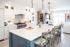 a large kitchen with an island in the middle and lots of counter space on one side