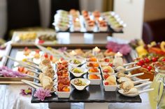 a table topped with lots of different types of food and candles in the middle of it