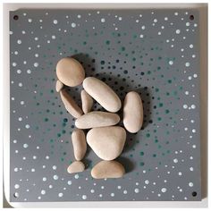 some rocks are laying on top of a gray and white polka doted board with dots