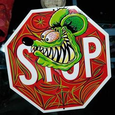 a stop sign with an image of a green creature on it's face and mouth