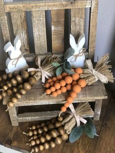 an old wooden chair with some candles and other items on it, including pumpkins