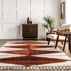 a brown and white rug in a living room next to a wooden cabinet with two vases on it