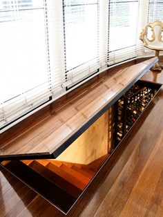 an advertisement for a wine cellar in the middle of a room with wooden floors and windows