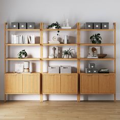 a wooden shelf with books and plants on it in front of a wall mounted bookcase