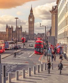 people are walking down the street in front of big ben