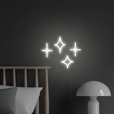 three stars are glowing in the night sky above a bed with pillows and lamps on either side