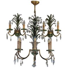 an antique chandelier with crystal drops hanging from it's arms and leaves