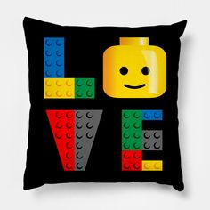 a black pillow with the word love made out of lego blocks and a smiling face