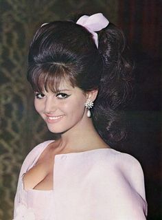 an old photo of a woman in a pink dress with a big bow on her head