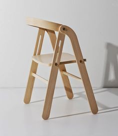 a wooden chair sitting on top of a white floor