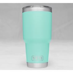 a mint green yeti cup sitting on top of a table