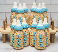 there are some rice krispy treats in the shape of boats on a boat with blue and white frosting