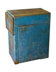 an old blue wooden cabinet with peeling paint on the door and bottom part, isolated against a white background