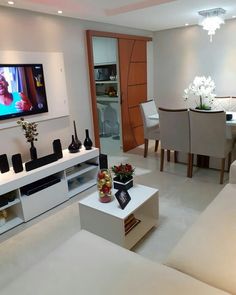 a living room filled with furniture and a flat screen tv