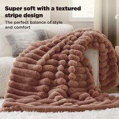 a large blanket sitting on top of a white couch