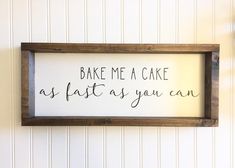 a sign that says bake me a cake as fast as you can on the wall