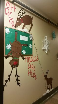 a decorated wall with reindeers and snowflakes hanging from it's sides