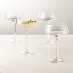 three glasses filled with different types of drinks