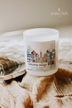 a white candle sitting on top of a wooden table