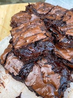 some brownies are sitting on top of a piece of parchment paper and ready to be eaten