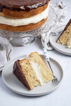 two slices of cake sitting on plates with one slice missing from the cake and another piece has been cut