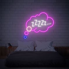 a neon sign above a bed in a room