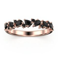 a rose gold ring with black stones