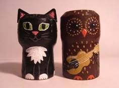 two decorative objects made to look like cats