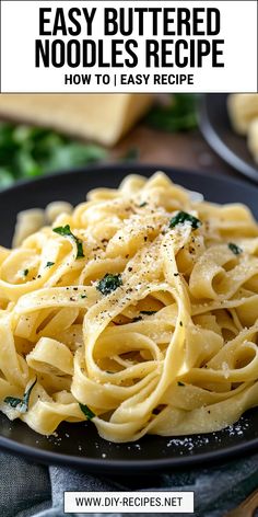 a black plate topped with pasta covered in parmesan cheese