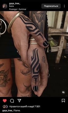 a person with tattoos on their arms and hands