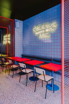 tables and chairs are lined up in front of a neon sign that reads cheeses make with me