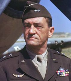 a man in uniform standing next to an airplane