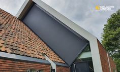 the roof of a building with a large window and an awning on it's side