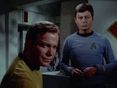 two men standing next to each other in front of a computer screen with the caption star trek