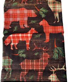 a scarf with animals on it and plaid fabric in red, green and black colors