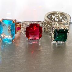 three different colored rings sitting on top of a table