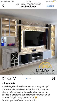 an entertainment center with built in shelving unit and led lighting on the back wall