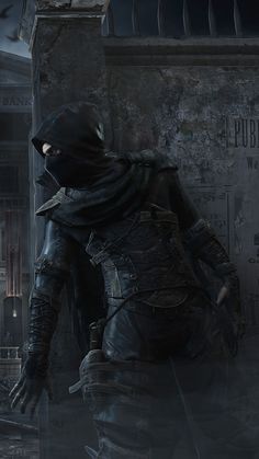 a man in a black outfit and hood standing next to a building