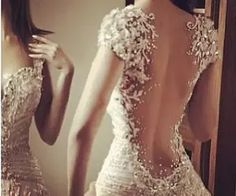 the back of a woman's dress with sequins on it