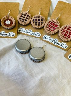 several different types of earrings are on display