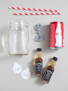 the ingredients to make an apple cider recipe are displayed on a white surface with red and white striped paper straws