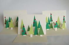 three christmas cards with trees on them, one is green and the other is white