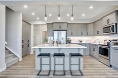 a kitchen with an island and three stools