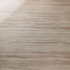 a close up view of a marble tile floor with light brown and white colors on it