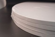 several white plates stacked on top of each other