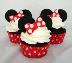 three cupcakes with minnie mouse decorations on them