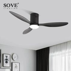 a black ceiling fan in a white room