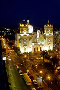 an aerial view of a church lit up at night