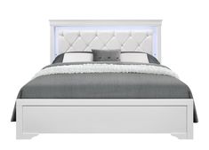 a white bed with an upholstered headboard and foot board